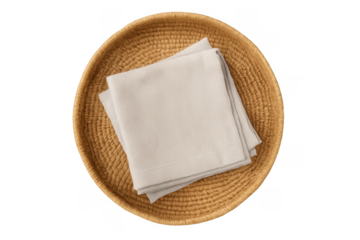 Beige linen napkins in woven wicker basket top view