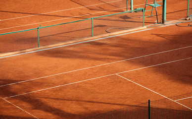 Clay tennis court marking lines and green net