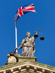 statue of justice with English flag