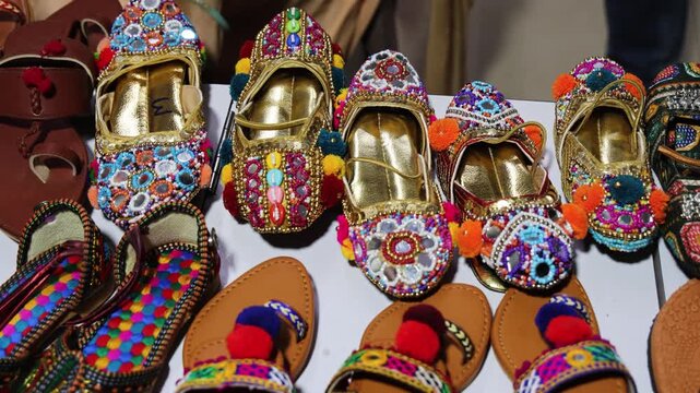 colorful traditional gujrati juttis or sleepers displayed at local market stall