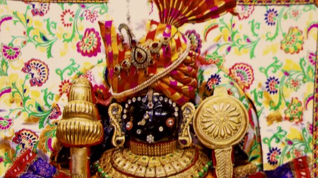 closeup of intricately decorated hindu god dwarkadhish statue with gem-studded attire