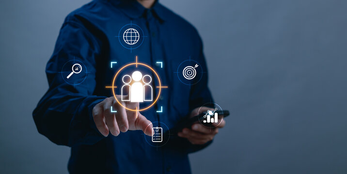 Businessman tapping on customer segmentation icon, representing audience analysis, data driven marketing concept, CRM strategy and modern technology to optimize customer reach