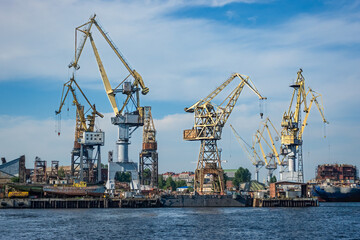 Fototapeta premium Industrial shipyard with numerous cranes along Saint Petersburg Neva River