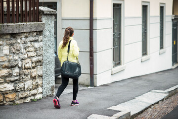 Young woman walks in the city alone