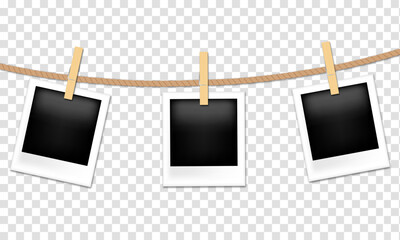 Photo frames hanging on rope with clothespins © Mariia