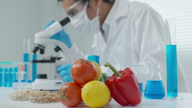 Scientist check chemical food residues in laboratory. Control experts inspect quality of fruits, vegetables. lab, hazards, ROHs, find prohibited substances, contaminate, Microscope, Microbiologist
