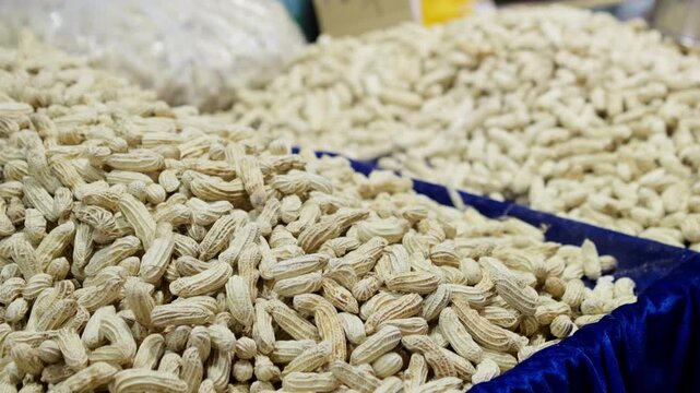 a lot of peanuts pile up, washed peanuts, and unpeeled peanuts