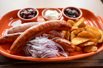 Savoring rich flavors of grilled sausages and tasty sides on a vibrant platter