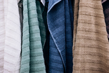 Hanging bathroom towels in assorted colors, close-up.