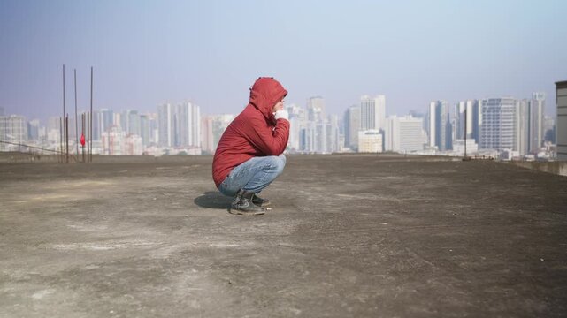 Asian man shows an Asian squat, flexible Asian squat, side angle
