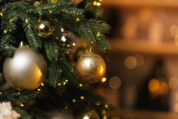 Closeup of decorated christmas tree with golden baubles and lights