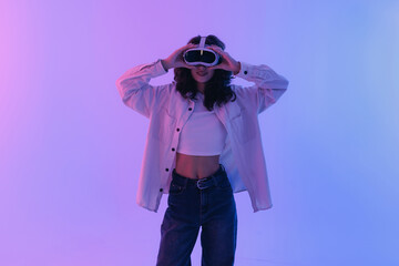 Fashion Portrait Young asian female experiencing virtual reality with headset in neon light. Concept gaming immersive technology