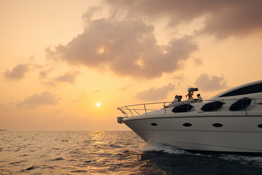Luxury yacht cruise at sunset with family enjoying a holiday on the open sea
