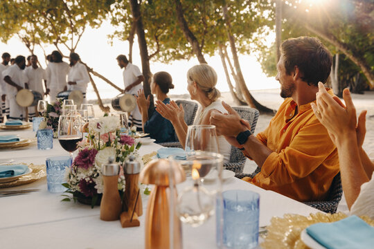 Guests enjoying live boduberu performance at luxury resort dinner
