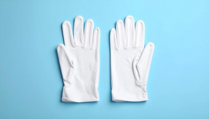 Obraz premium White Fabric Gloves with Gathered Cuffs on Light Blue Surface
