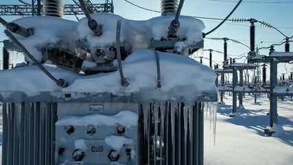 Snowcovered power station transforms under the morning sun, revealing the resilience of energy infrastructure. capturing the delicate balance between nature and technology.