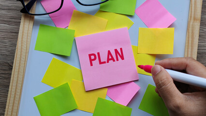 Business Plan Concept with Pink Sticky Note on Colorful Background for Goals, Strategy, Organization, and Future Success