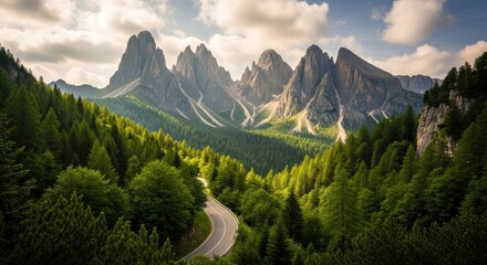A winding road through a lush forest with majestic mountains in the background.