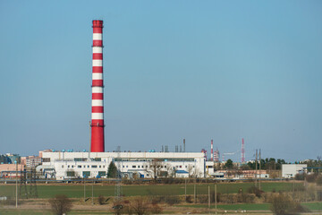 A large industrial plant. The high pipes of the factory emit harmful substances into the atmosphere. Environmental pollution.