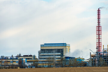 A large industrial plant. The high pipes of the factory emit harmful substances into the atmosphere. Environmental pollution.