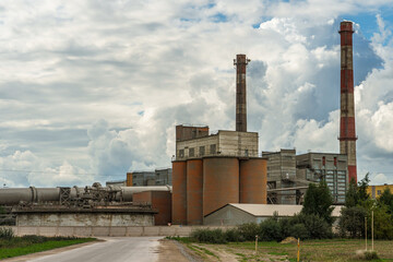 A large industrial plant. The high pipes of the factory emit harmful substances into the atmosphere. Environmental pollution.