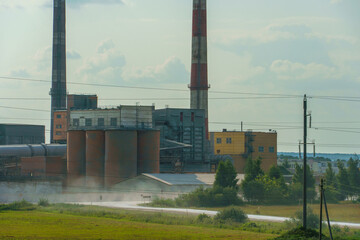 A large industrial plant. The high pipes of the factory emit harmful substances into the atmosphere. Environmental pollution.