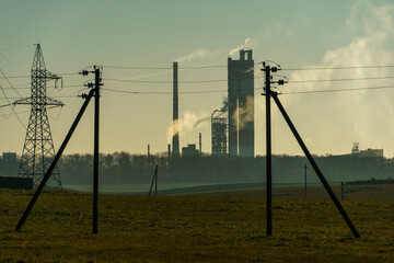 A large industrial plant. The high pipes of the factory emit harmful substances into the atmosphere. Environmental pollution.