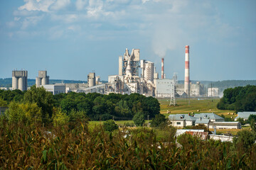 A large industrial plant. The high pipes of the factory emit harmful substances into the atmosphere. Environmental pollution.