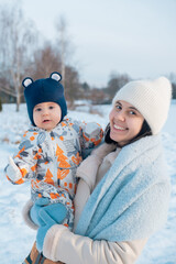 Smiling Mother and Baby Enjoying a Winter Day