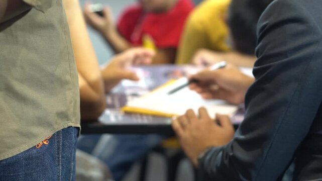 People are working on documents. Blurred focus. Slight shaking.