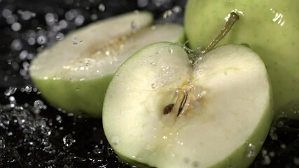 Cutting green apples and splashing water in a kitchen at midday - Powered by Adobe