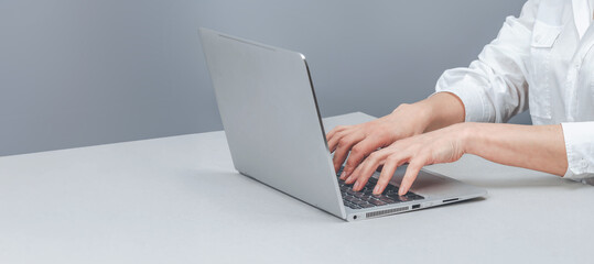 Hands typing on laptop keyboard. Zoom, person with keyboard for editing. Working with laptop concept