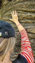 Woman hugging a large tree trunk