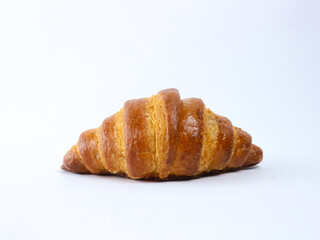 Golden croissant isolated on a clean white background. Close-up baked pastry ideal for menus, bakery promotions, packaging, and commercial food advertising