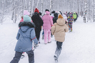 Excited Children Enjoying a Memorable Winter Wonderland Adventure Deep in a Snowy Forest, A lively group of children joyously exploring a beautiful snowcovered forest,