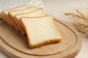 Slices of toast bread on beige table, closeup