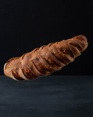 A loaf of gray bread with figs hung in the air.