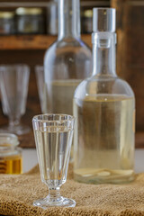 Horseradish tincture. Homemade strong alcoholic drink with horseradish and honey. Bitter. Rustic style. Selective focus