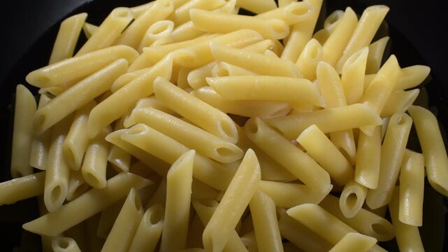 Just boiled macaronis in black background