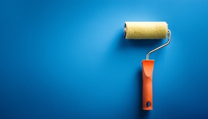 Obraz premium paint roller on vibrant blue background