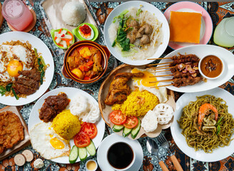 Stunning overhead feast of vibrant Indonesian cuisine featuring satay, curry, and colorful rice spreads
