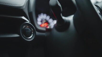 Close-up view of modern car interior featuring engine start-stop button and gear shift, showcasing sleek design and advanced technology in automotive engineering