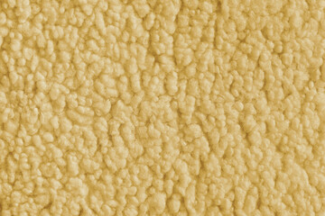 Vibrant yellow color fabric texture of soft faux fur cloth with fluffy surface, abstract background. Close up, macro of shaggy fabric texture, upholstery material, textile backdrop © katyamaximenko