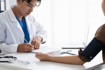 Doctor checking  patient arterial blood pressure. Health care measuring blood pressure of patient