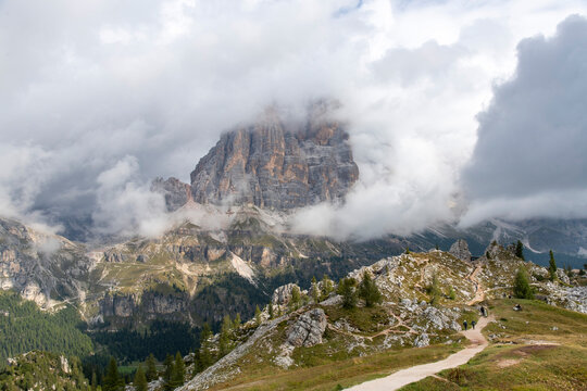Tofana di Rozes mountain of Dolomite Alps or Pale Mountains name from carbonate rock dolomite in Veneto, Italy part of Limestone Alps near Cortina d'Ampezzo surrounded by low hanging white clouds