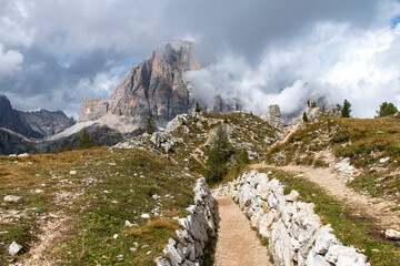 WW1 trenches near Cinque Torri rock formation with Tofana di Rozes rock formation in background of Dolomite Alps named from carbonate rock dolomite in Veneto, Italy part of Limestone Alps