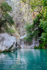 Stunning narrow Goynuk gorge with majesty of cliffs and turquoise waters. Dramatic rock formation towering over Goynuk canyon waters, Turkey.