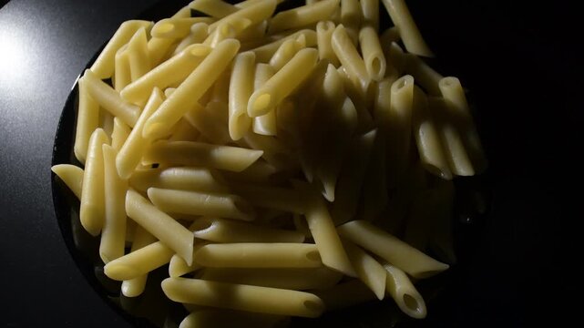 Just boiled macaronis in black plate