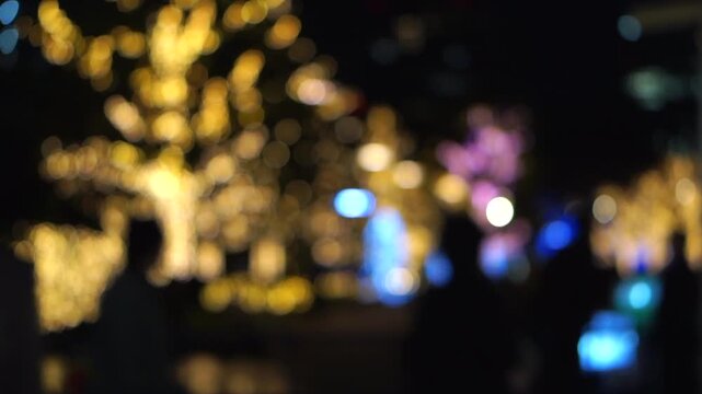 Tokyo during winter christmas decoration at night people walking wih blur illumination tree