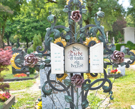 Wundersch&ouml;nes Blumenverziertes Eisenkreuz mit einem Frommen Wunsch auf dem Katholischen Friedhof in Kempten - Allg&auml;u